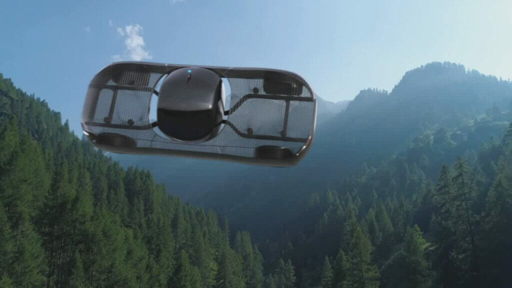 Futuristic flying car gliding through a mountainous landscape with dense green forests and clear blue skies.